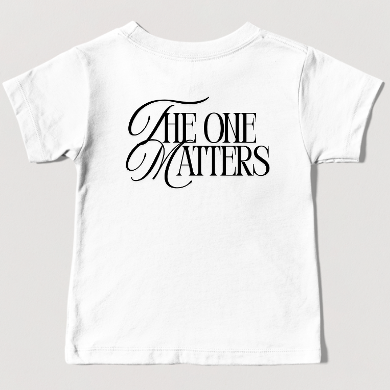 back of white t-shirt with a The One Matters graphic text on a light gray background